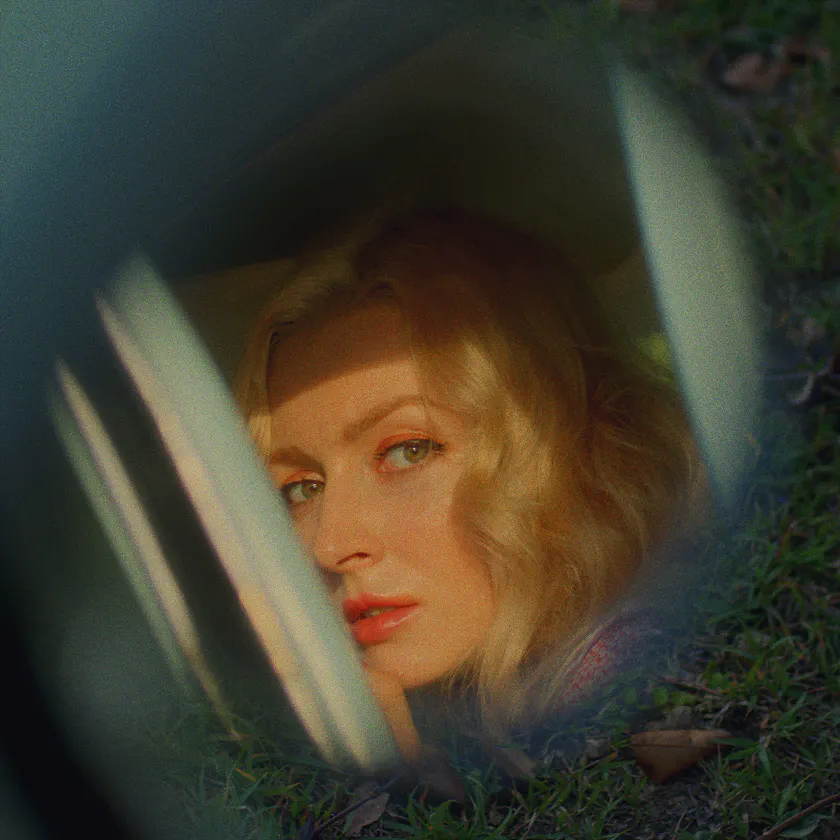 Prokudin-Gorskiy 1906 Experimental — Monochrome portrait of a blonde woman seen through a car window and grass.